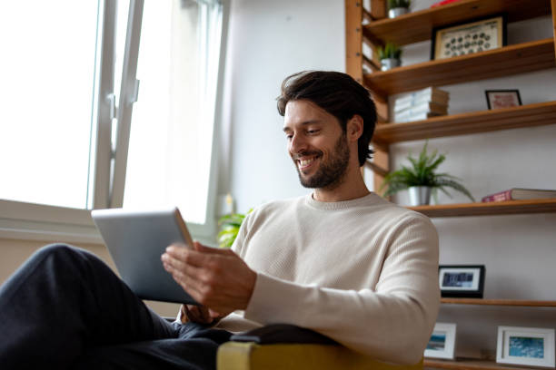 istock Low angle photo of a man using digital tablet 1934511739