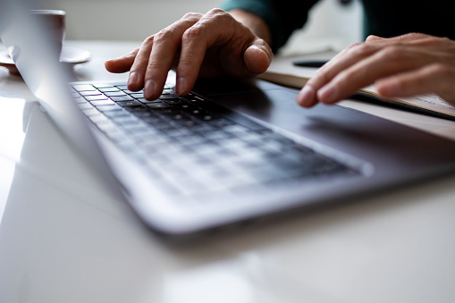 Close up of man hand typing on keyboard