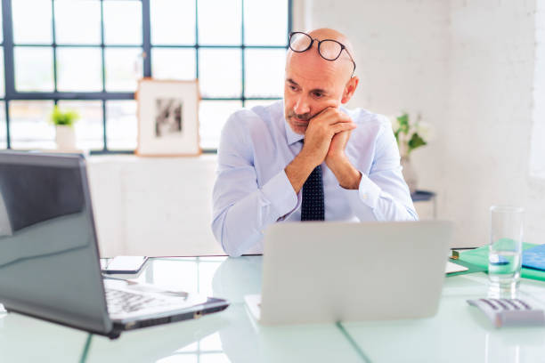 istock Worried businessman sitting at the office and using laptop for work 1934523174