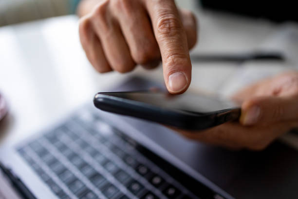 istock Focus on man hand holding mobile phone 1934523699