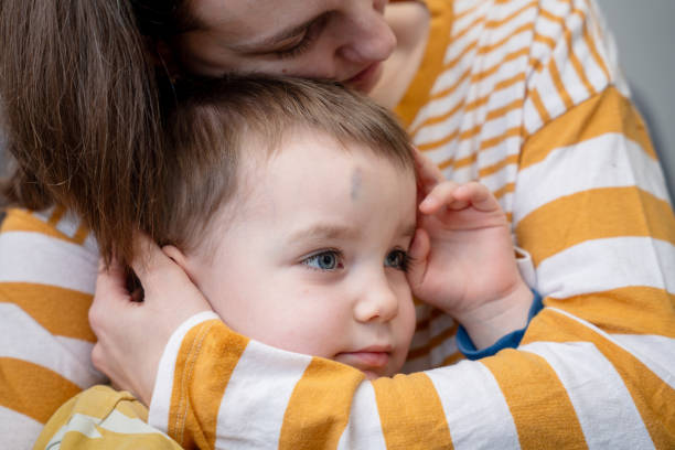 istock Loving mother comforting son with bruise on the forehead 1934534775
