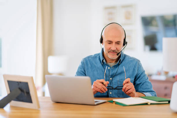 istock Male customer service assistant businessman wearing headset and using laptop for work 1934545450