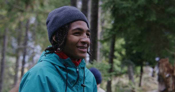 istock African American young hiker keeps metal cup in hand and talks 1934589398