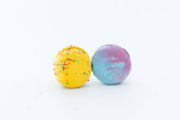 istock Sweet colorful macarons isolated on white background. Tasty colorful macaroons. Two multi-colored blue and yellow macaroons. French pastry made from egg whites. 1934593746