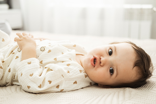 Beautiful portrait of baby with white blanket - Stock photo