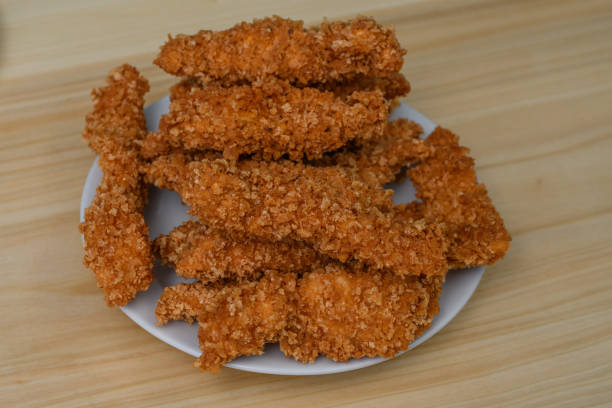 istock Plate full of panko breaded chicken strips, isolated close up 1934601734