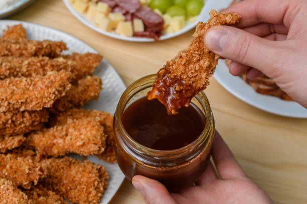 istock Panko-breaded chicken dipped in bbq sauce is on the table among other snacks 1934602829