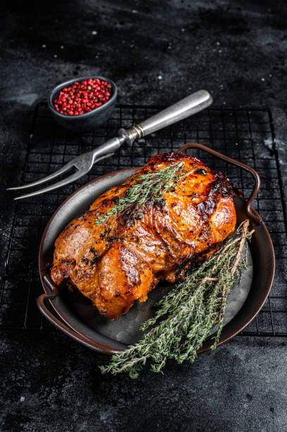 istock Roasted Glazed Pork meat Roll with thyme and tomato sauce. Black background. Top view 1934613763