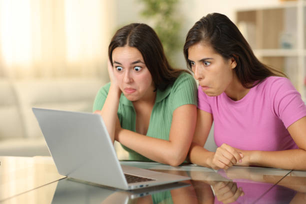 istock Perplexed friends checking laptop at home 1934618553