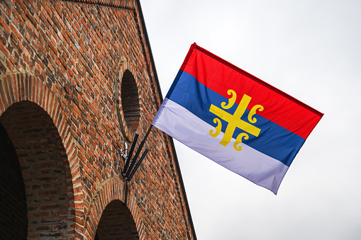 Serbian orthodox church flag with serbian cross 4S symbol, low angle view