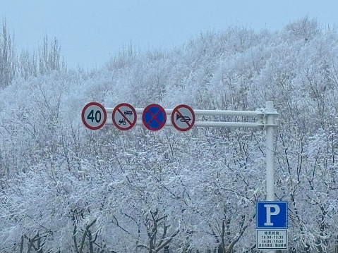 Road sign under snowy scenery