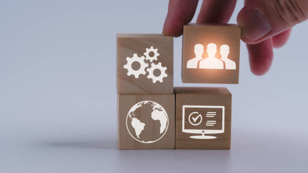 istock a wood cube block in hand putting on wooden puzzles stacking arranging completed business teamwork goal and success plan concept 1934620178