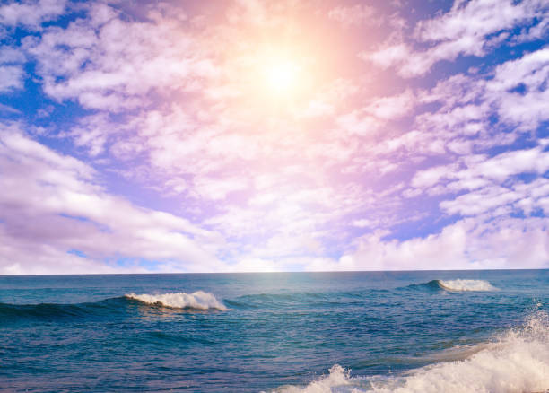 Sea tropical beach and sun on blue cloudy sky.