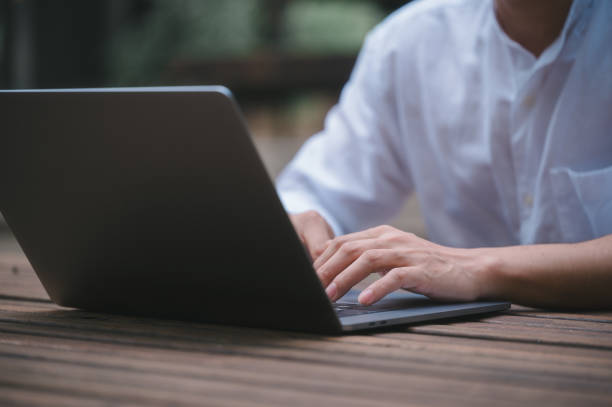 istock a businessman or freelancer using computer laptop sitting on table outside working on business or internet online marketing 1934624487