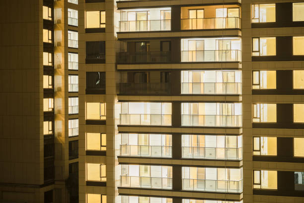 istock Modern residential building with lights on at night 1934633123