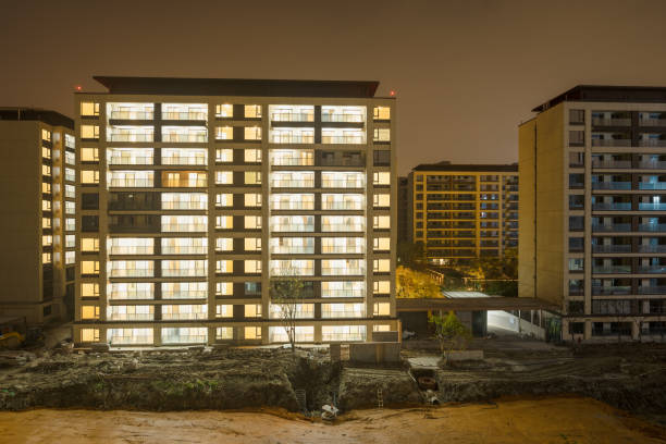 istock Modern residential building with lights on at night 1934633657