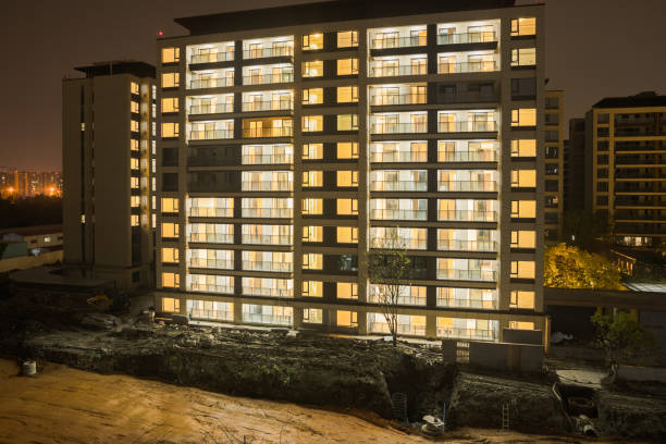 istock Modern residential building with lights on at night 1934634223