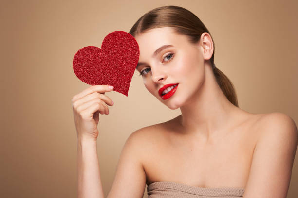 istock Beautiful woman holding an artificial red heart 1934639710