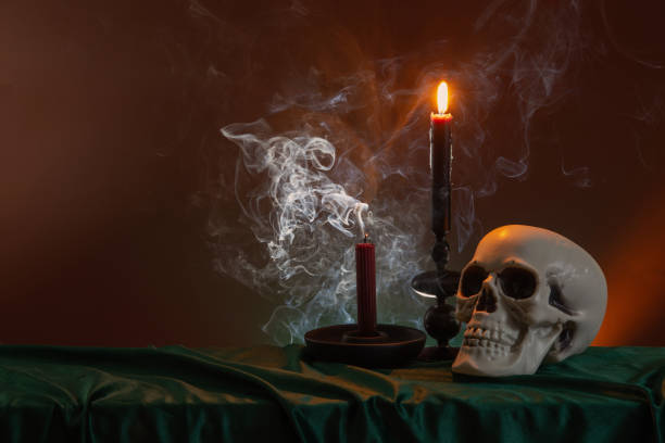 istock scull and burning candles with halloween decor on dark background 1934682713