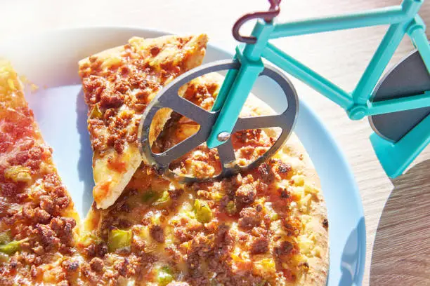 Kitchen pizza cutter like a bicycle on wooden table