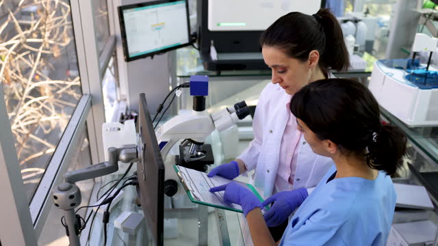Team of female medical researchers working together at the laboratory