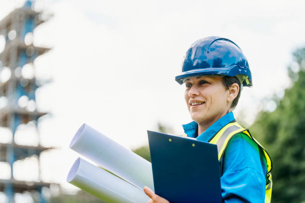 female site engineer surveyor working with theodolite total station edm equipment on a building construction site outdoors - people in a row in a row business office worker zdjęcia i obrazy z banku zdjęć