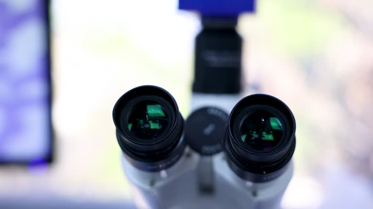 Close up of a microscope and the view of the sample on screen at a laboratory