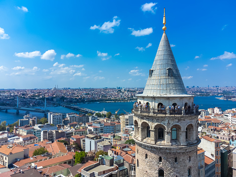 Istanbul, Turkey - September 1 2023: Close-up view of the Galata Tower with tourists, one of the historical symbols of Istanbul. View of Galata Tower, Istanbul on a sunny bright day.