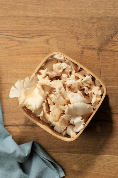 istock A Group of White Oyster Mushroom on Wicker Basket on Brown Wooden Table Ready to Cook in the Kitchen 1934732736