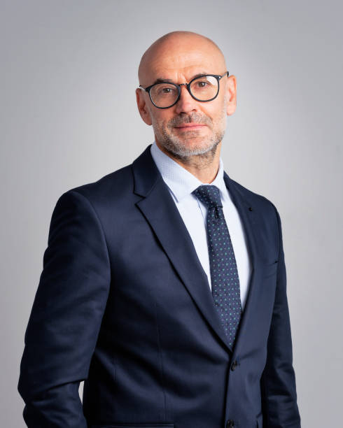 Confident businessman wearing suit and tie agains isolated background stock photo