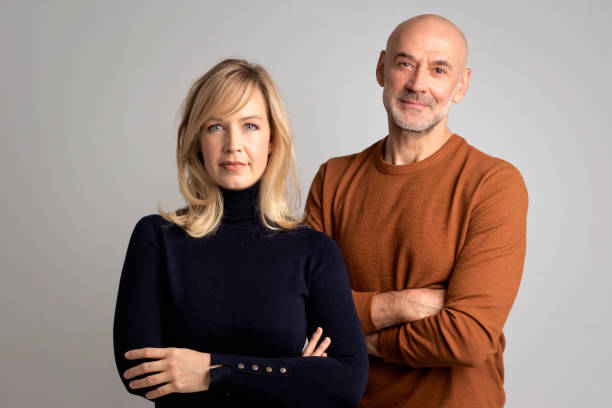 istock Smiling couple against white background 1934746833