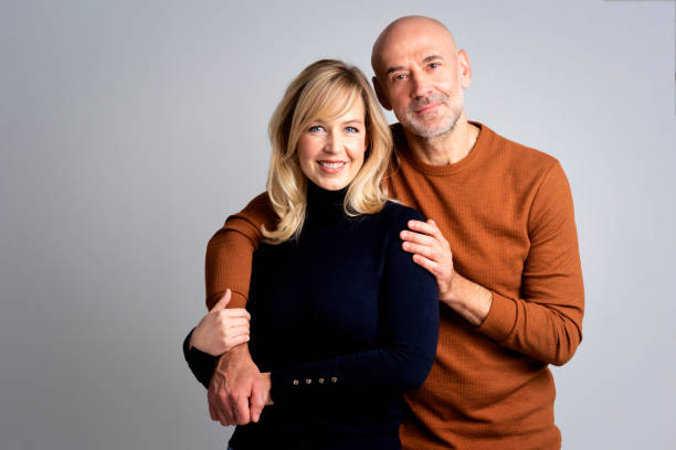istock Smiling couple against white background 1934747232