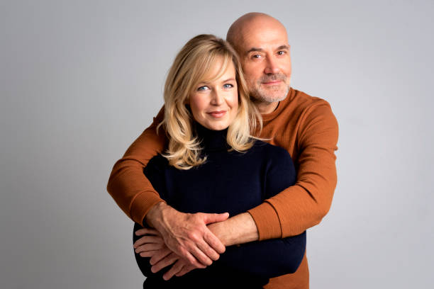 istock Smiling couple against white background 1934747266
