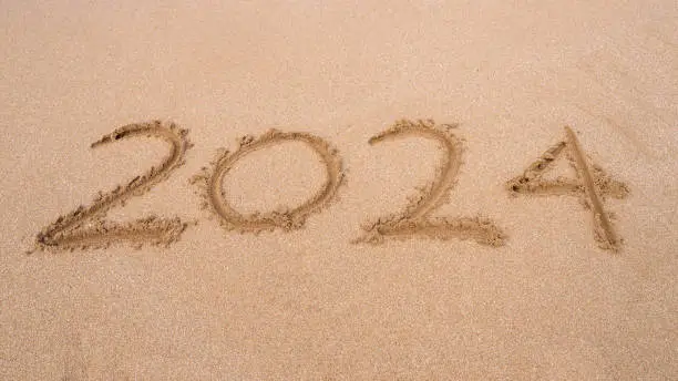2024 written in the sand on a beach in Puerto Rico
