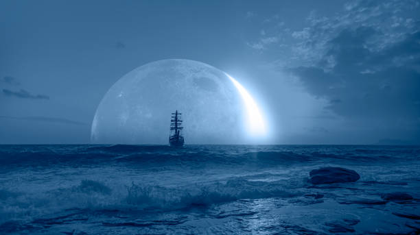 istock Sailing old ship in storm sea - Night sky with crescent moon in the clouds 1934768266