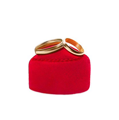 Gold wedding rings on red velvet gift box heart on white background. Marriage, proposal, Valentine's day. Vertical. Copy space
