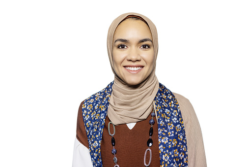 Portrait of happy young Muslim woman on white background. Smiling Middle Eastern female with hijab in studio.