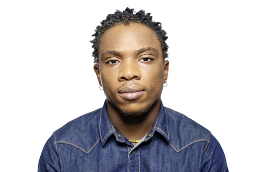 Portrait of young african man looking at camera with serious expression. Handsome man staring at camera on white background.