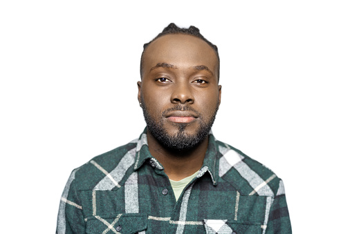 Portrait of African American young man with braided hair on white background. Confident African male staring at camera in studio.