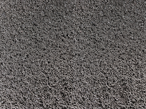 black sponge foam material surface background. textured absorbent material and coarse pores