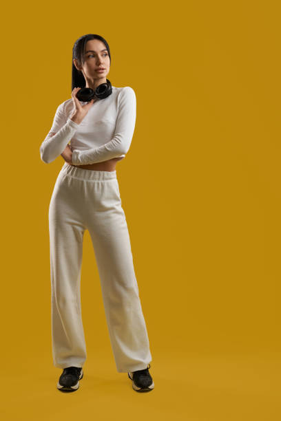 istock Trendy female dj in sportswear looking away, while standing in spacious studio. 1934807346