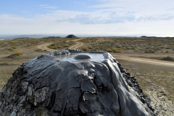 Mud volcano - bubbling crater, Gobustan, Azerbaijan Gobustan, Azerbaijan: mud spewing out from the earth due to compactional stress, Azerbaijan has the most mud volcanoes in the world, with around 300 of them, around a third of all mud volcanoes in the world. The gas that the mud volcanoes emit consists of 90% highly flammable methane. The mud contains iodine, bromine, calcium and magnesium and is rich in minerals. The mud is said to have health-promoting effects on the skin. mud volcano stock pictures, royalty-free photos & images