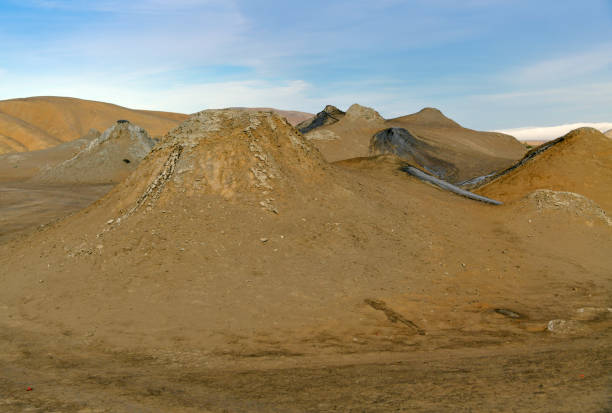 Gobustan, Azerbaijan: field with craters of mud volcanoes - mud spewing out from the earth due to compactional stress, Azerbaijan has the most mud volcanoes in the world, with around 300 of them, around a third of all mud volcanoes in the world, some thought to have medicinal qualities. Their occurrence in the area around Qobustan is closely linked to the oil and gas deposits there.