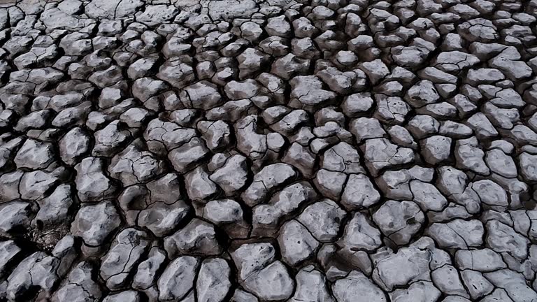 Dramatic geometric shapes formed in dried up mud of a river