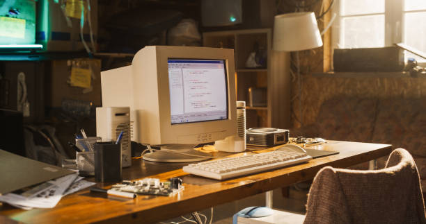 istock Close Up Shot Of Old Desktop Computer On Work Desk Of Software Engineer In Retro Garage. Dated PC Has Operating System Terminal Opened, Prompts Running On Screen, Code Functioning Successfully. 1934843911
