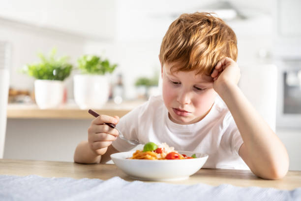 istock A cute little boy is having lunch but he doesn't like spaghetti. 1934848147
