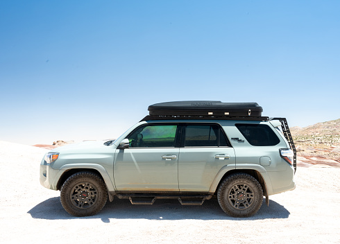 Capitol Reef National Park, United States: June 19, 2023: Bright Exposure of Profile Of Toyota 4Runner With Roof Top Tent In Desert