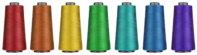 Multiple sewing threads of different colours in a plastic box