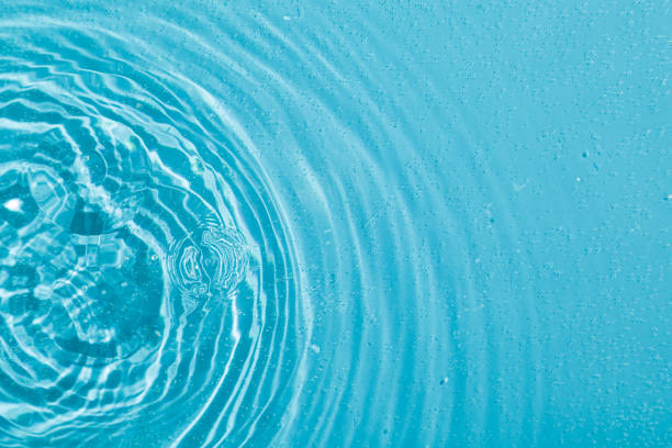 istock drops on water with circles on a blue background 1934851854