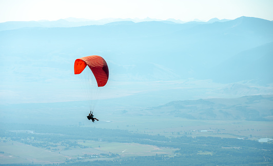 Grand Teton National Park, United States, July 16, 2022: Paraglider Flying Over Jackson Hole